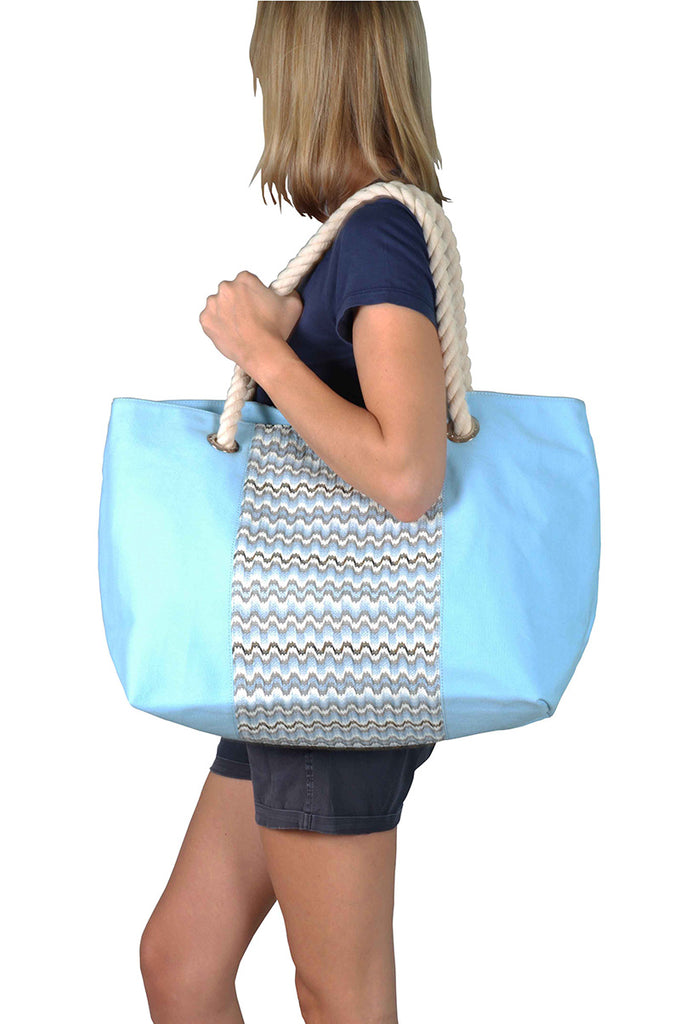 Woman wearing a beach bag with cotton handles