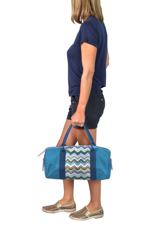 woman carrying a blue canvas gym tote bag 