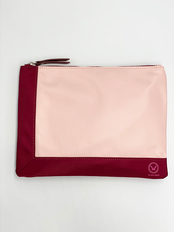 A stylish pink plum water resistant pouch with zipper made of 100% polyester and faux leather that can be used as a cosmetic bag.