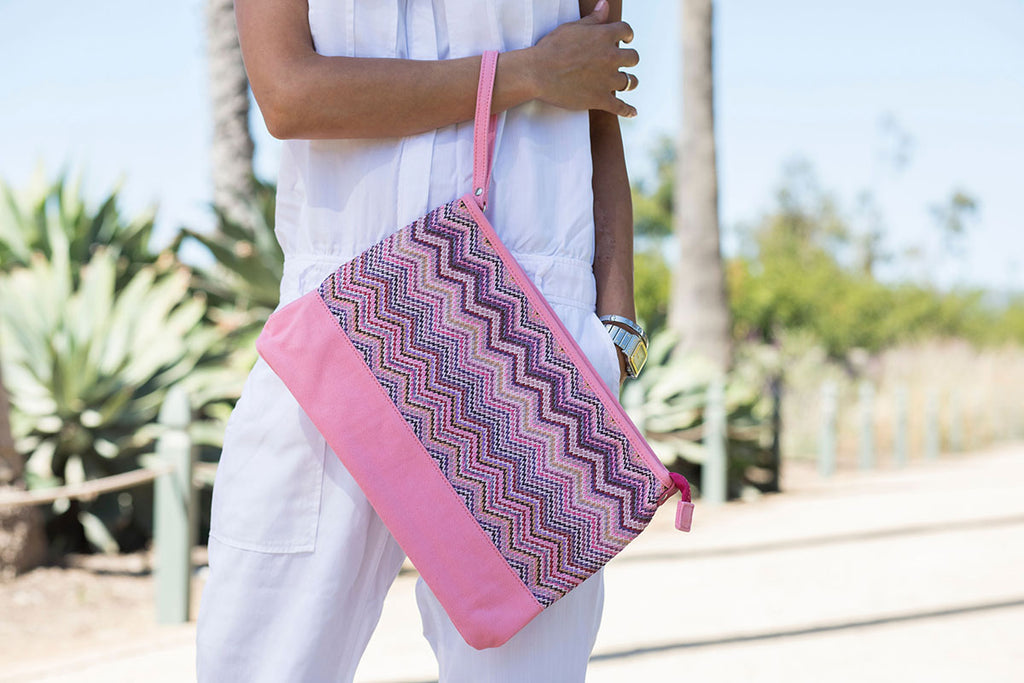 model carrying a pink cosmetic travel bag