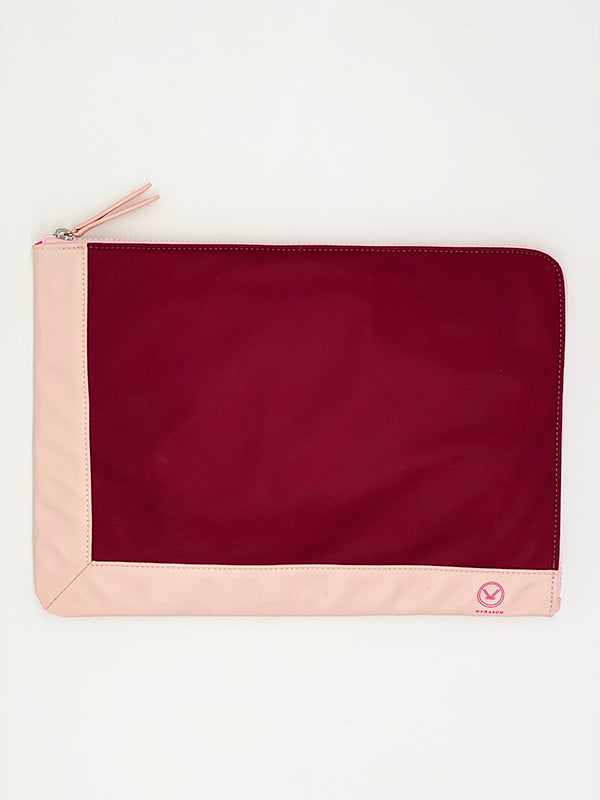 A chic fully padded laptop sleeve made by water-resistant nylon and faux leather in the color of plum and pink.