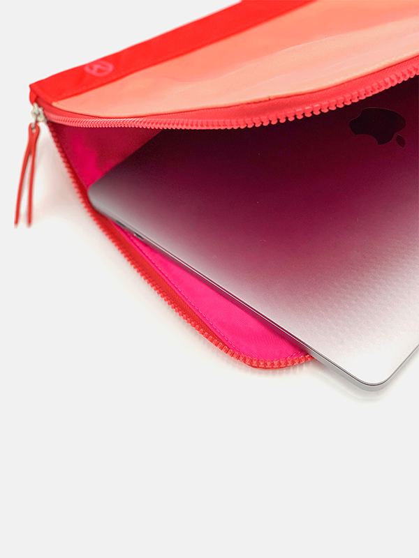 A chic fully padded laptop sleeve made by water-resistant nylon and faux leather in the color of red and coral.