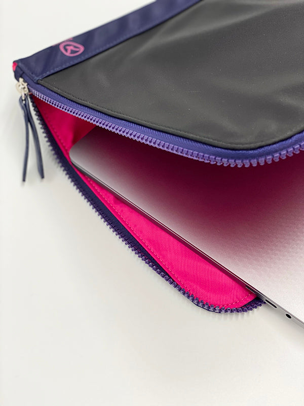 A chic fully padded laptop sleeve made by water-resistant nylon and faux leather in the color of jet black and blue.