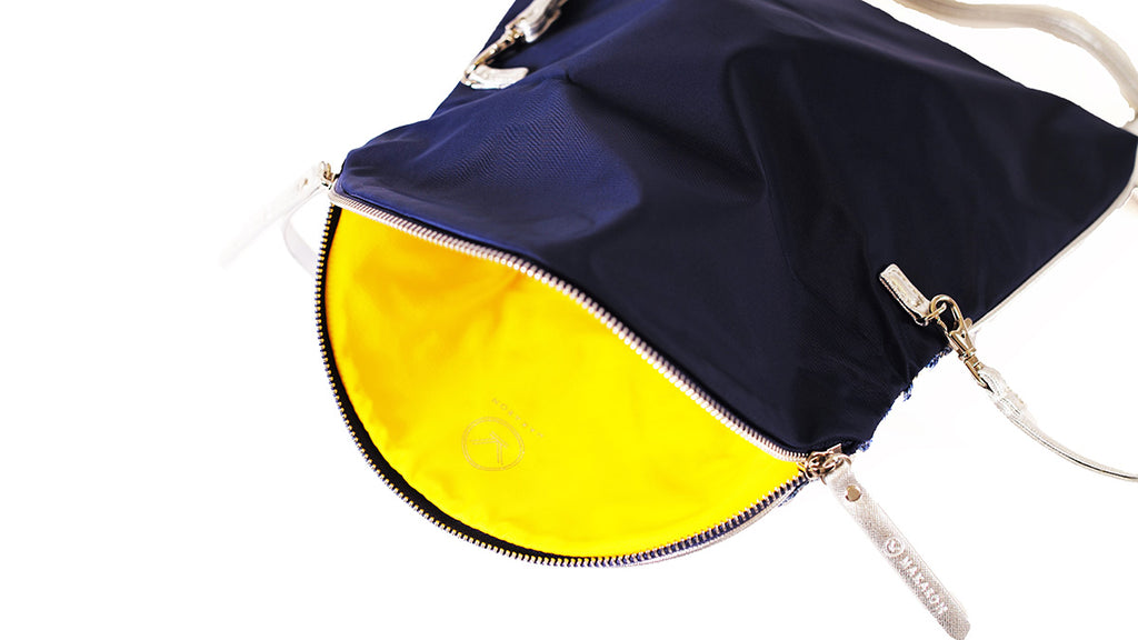 Navy blue crossbody bag with yellow lining