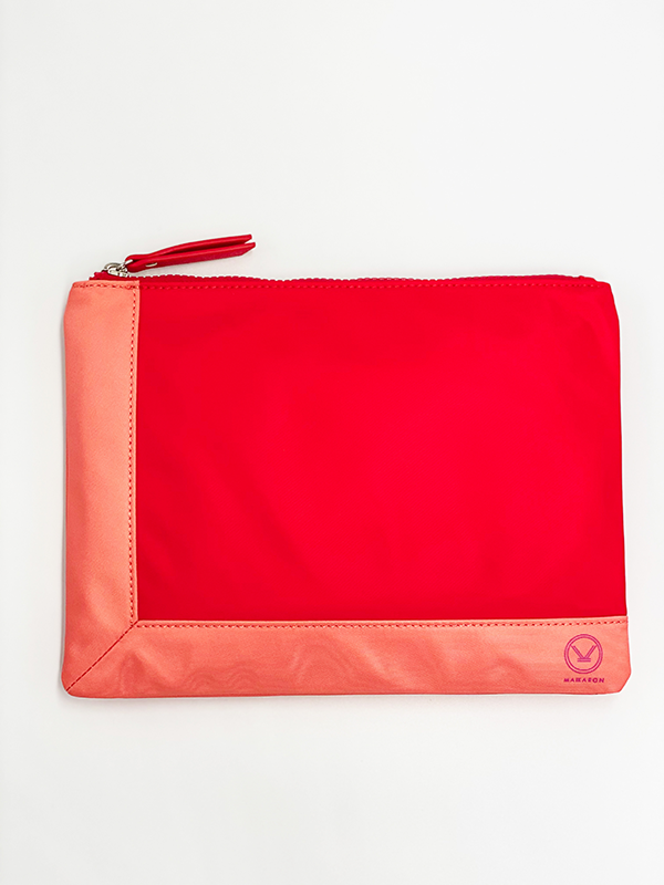 A stylish red coral water resistant pouch with zipper made of 100% polyester and faux leather that can be used as a cosmetic bag.