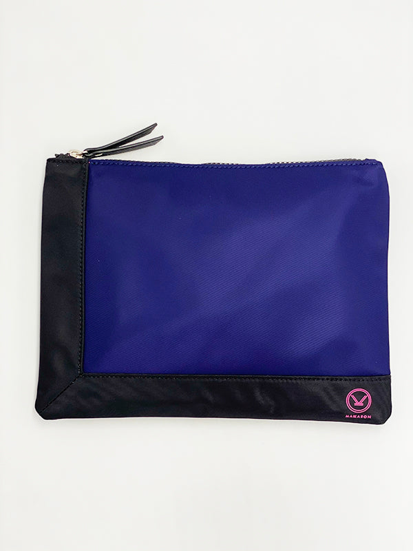 A stylish blue black water resistant pouch with zipper made of 100% polyester and faux leather that can be used as a cosmetic bag.