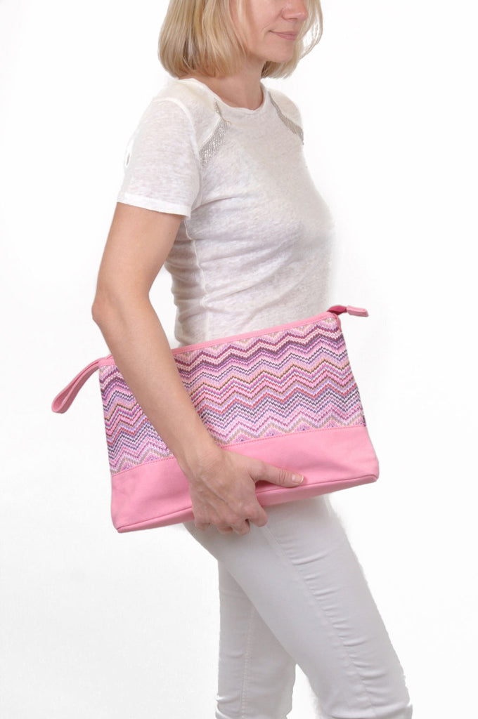 woman wearing a pink travel makeup bag