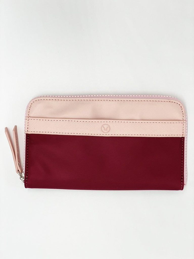 A pink plum water resistant wallet that has a lot of space for cards and notes, completed with a chunky YKK zipper.