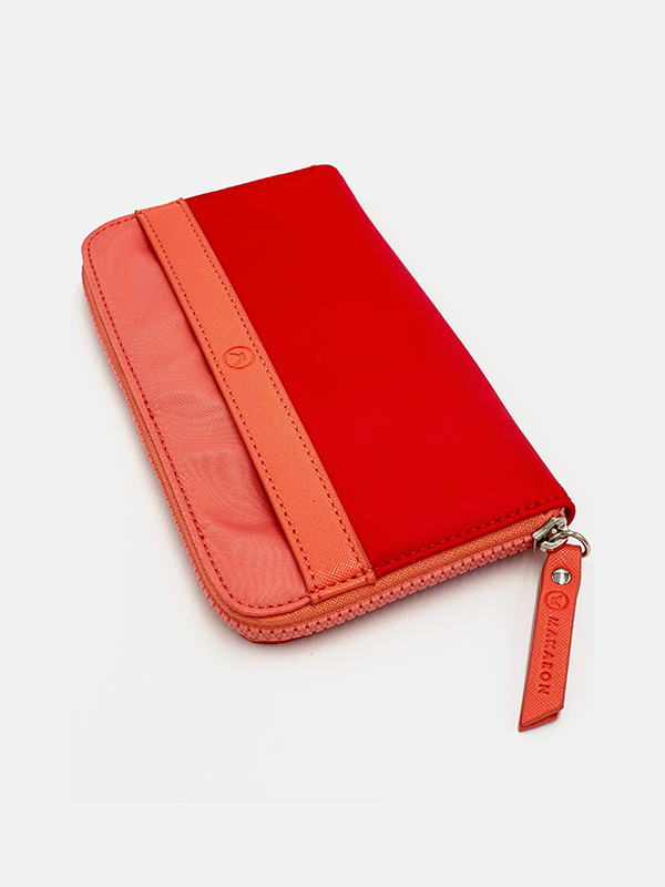 A red & coral water resistant wallet that has a lot of space for cards and notes, completed with a chunky YKK zipper.