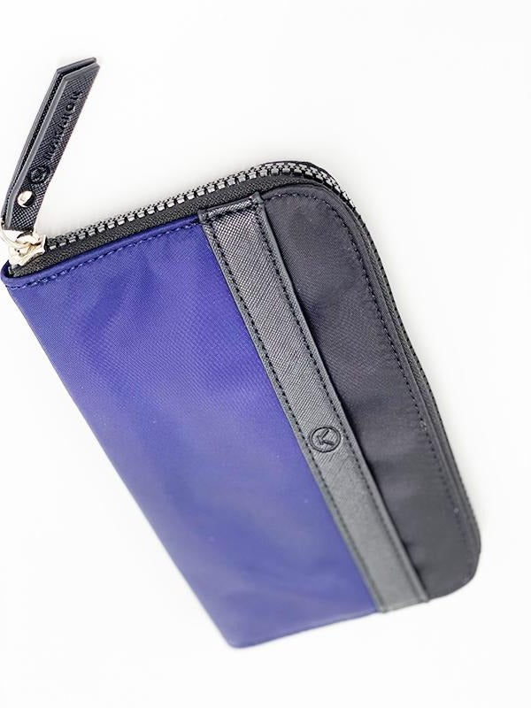A blue black water resistant wallet that has a lot of space for cards and notes, completed with a chunky YKK zipper.